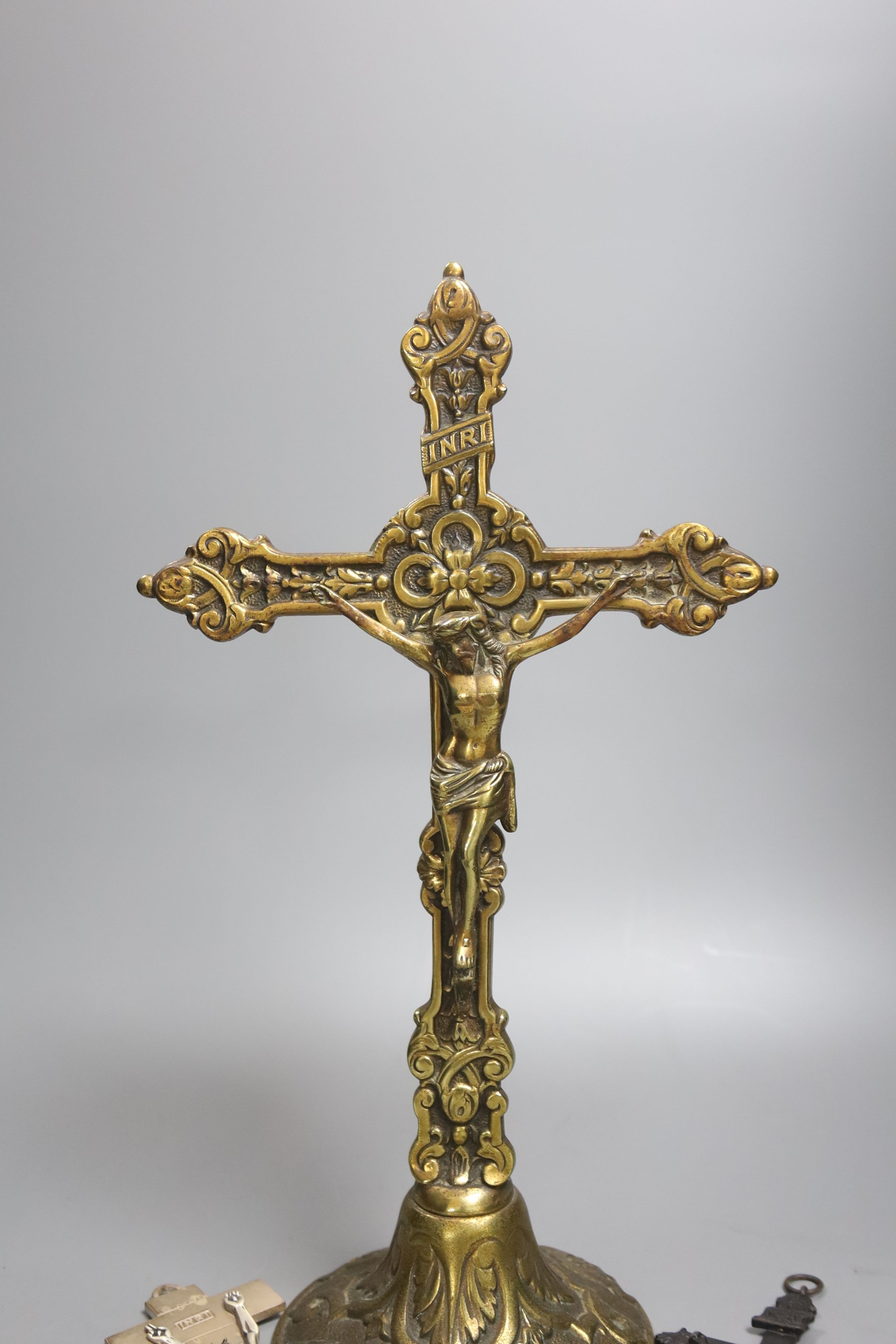 A group of four brass and metal crucifixes, largest 34cm
